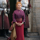 queen standing outside a castle